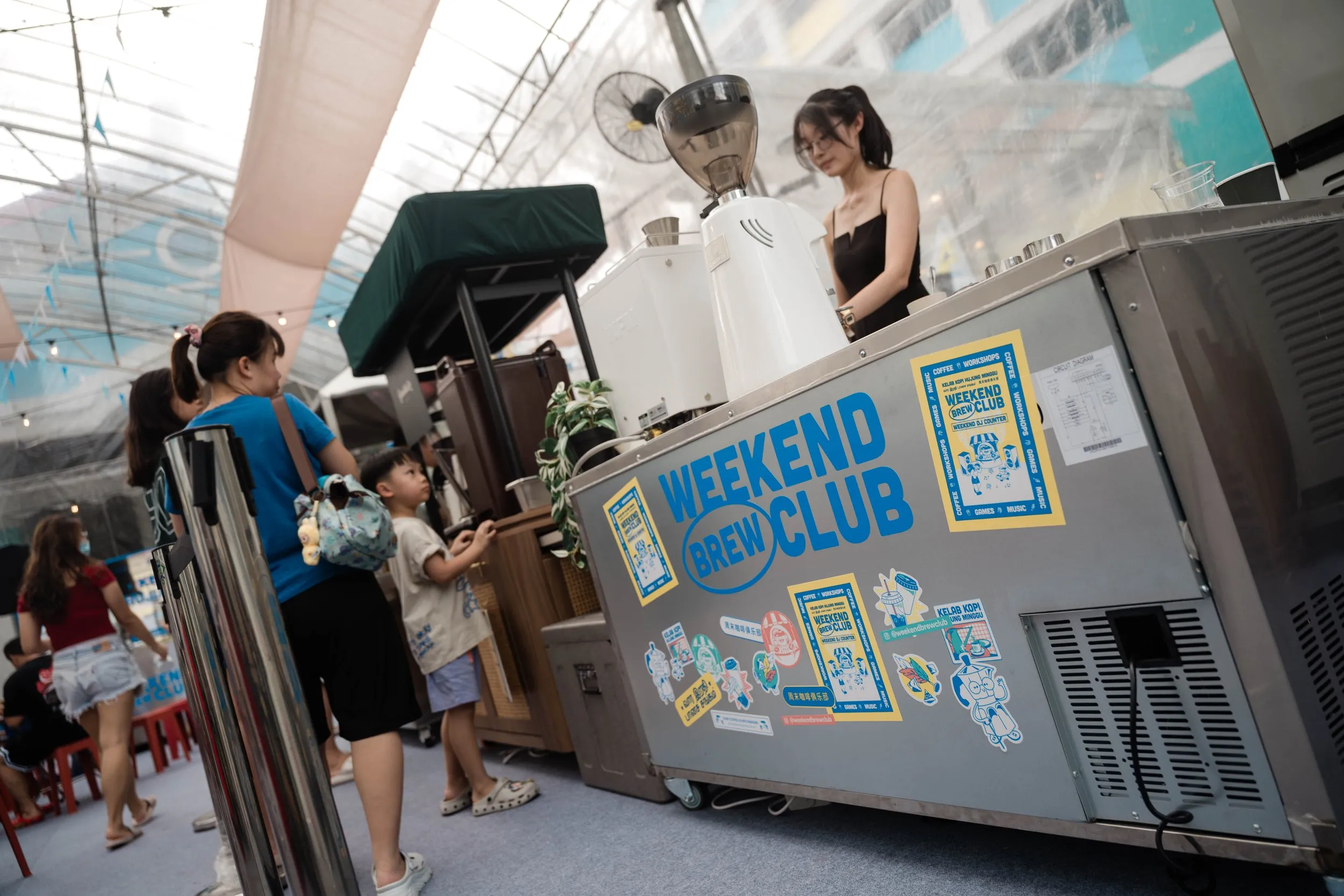 Genista Ln kopi cart beside the Weekend Brew Club counter at the WBC Keat Hong event, 2026